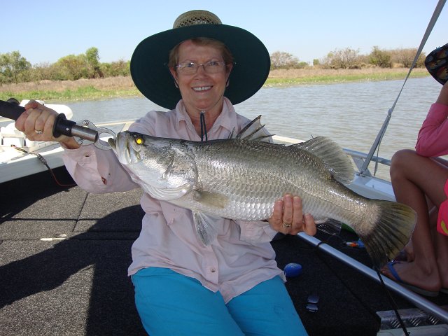 DSC04653.JPG - Sylvia with a 60cm Barramundi, arguably the #1 gamefish in Australia.  They're in the Corroboree Billabong, where part of Crocodile Dundee was filmed.