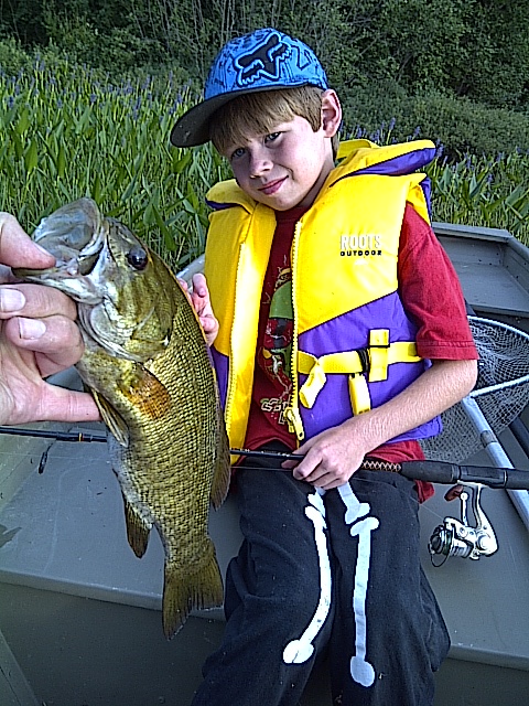 IMG-20110727-00176.jpg - Julien with a smallmouth from the Cottage."Thanks again for the patience and outstanding customer service.  Julien and I really enjoy visiting your shop.Roger."