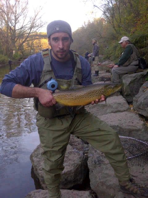 IMG-20111102-00065.jpg - Nick with a beautiful brown trout caught while fishing in Olcott at Burt Dam.