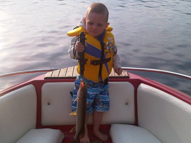 IMG00335-20110627-1931.jpg - Lucas caught his first Pike and is checking its weight! (Much heavier than his dads'!)