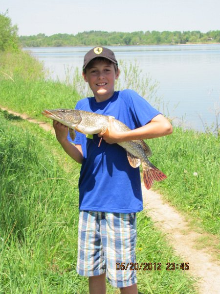 038_43634634.JPG - Paul caught this pike with a banjo 006 minnow – it’s my first pike he’s caught – the smile say it all – who cares about a little fish slime on the shirt. Mom does the laundry anyways !.