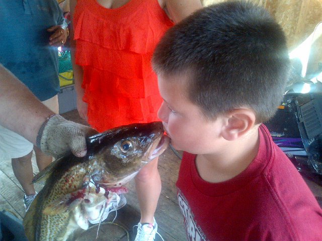 IMG-20120730-00440.jpg - Dad told Aidan that you're not a true Newfoundlander until you have "kissed the cod"...and he believed him !!