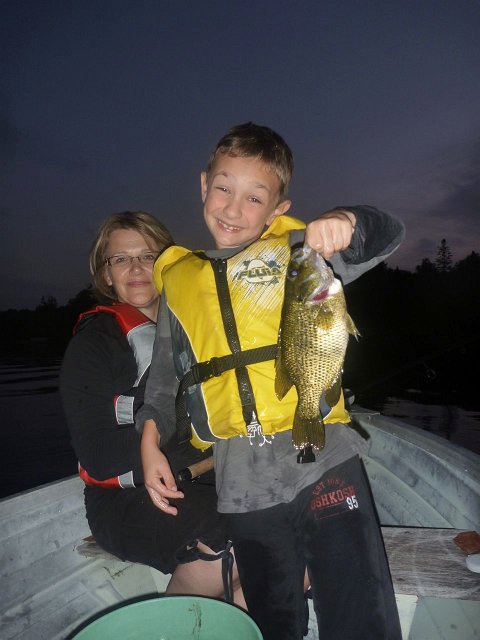 P1180155.jpg - This big Rock Bass was part of a multi species evening of fish on Soyers Lake. (The cameo appearance is mom Kathy).
