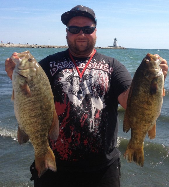 mark47626563456.JPG - Mark with two nice Smallmouth Bass from Lake Erie caught with his "beloved O.S.P."  soft plastics.
