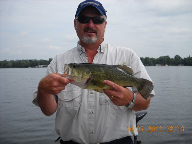 rob_001.JPG - Rob and a largemouth caught on a crankbait in 8 foot of water.